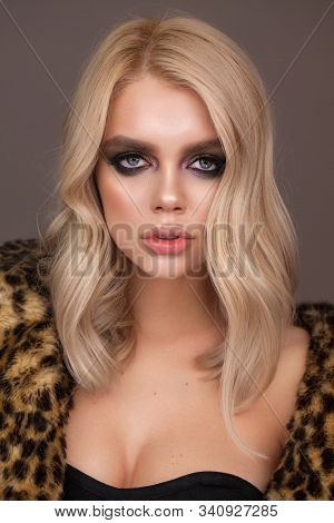 Attractive Fashion Model With Blue Eyes, Blond Hair, Trendy Smokey Eyes And Nude Lips. Fur Leopard C