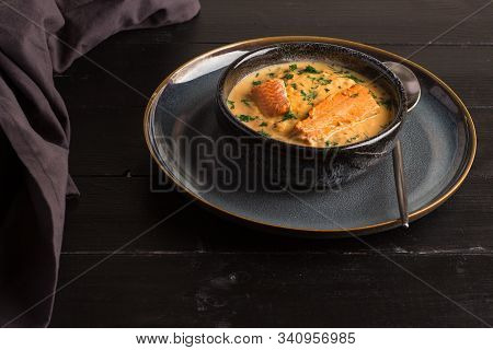 Salmon Creame Soupe In Bowl With Spoon On Wooden Table