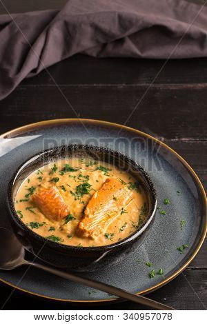 Salmon Creame Soupe In Bowl With Spoon On Wooden Table