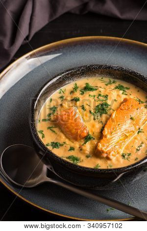 Salmon Creame Soupe In Bowl With Spoon On Wooden Table