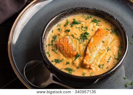 Salmon Creame Soupe In Bowl With Spoon On Wooden Table