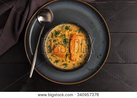 Salmon Creame Soupe In Bowl With Spoon On Wooden Table