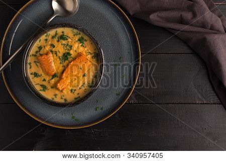 Salmon Creame Soupe In Bowl With Spoon On Wooden Table