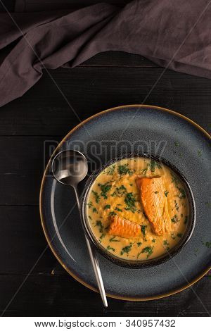 Salmon Creame Soupe In Bowl With Spoon On Wooden Table