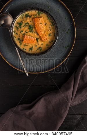 Salmon Creame Soupe In Bowl With Spoon On Wooden Table