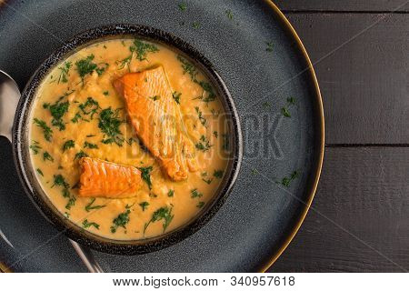 Salmon Creame Soupe In Bowl With Spoon On Wooden Table