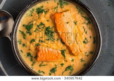 Salmon Creame Soupe In Bowl With Spoon On Wooden Table