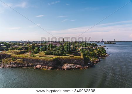 Suomenlinna Fortress Island Outside Helsinki On A Bright Summer Day With Green Trees And City Far In