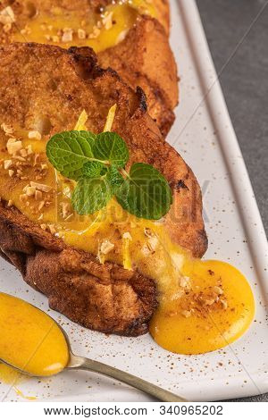 Traditional Christmas Rabanadas With Egg Yolk Cream And Cinnamon. Spanish Torrijas Close Up On The C