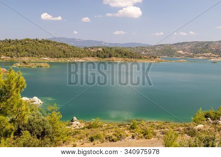 Scenic View At The Gadoura Water Reservoir On Rhodes Island, Greece With Blue And Turquoise Water An