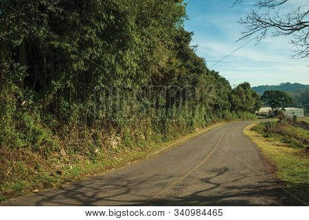 Bucolic Rural Landscape With Asphalt Road Going Through The Hill And Woods In A Cloudy Day Near Bent