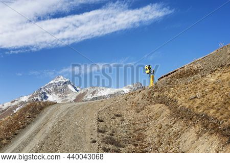 Yellow Snow Maker On The Mountainside. Active Tourism And Winter Sports.
