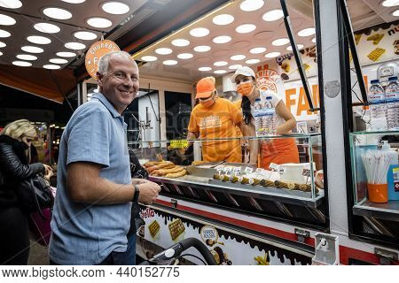 Faro, Portugal - October 22, 2021: A Man Buying Sweet Churros At Santa Iria Festival