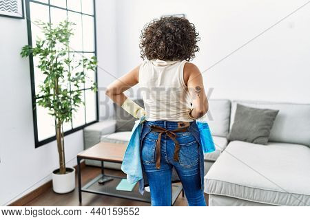 Young middle east woman holding cleaning cloth and spayer at home