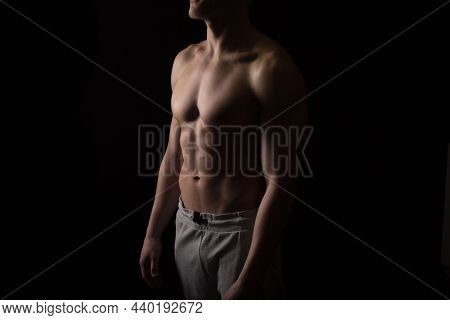 Man Showing Abs. Muscle Man Posing. Strong Body Concept. Topless Sport Man Bodybuilder. Six Pack Spo