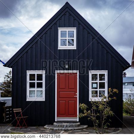 Hafnarfjordur, Iceland - July 17, 2021: A Black, Traditional Wooden Icelandic House. Cloudy Sky. No 