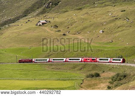 Disentis, Switzerland - August 14, 2021: The Glacier Express Is A Tourist Panoramic Train That Cross