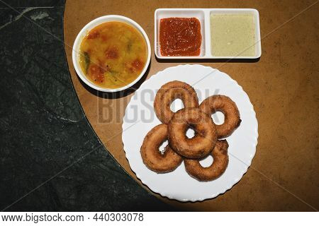 Tasty Homemade South Indian Deep Fried Medu Wada Served With Homemade Sambhar, Coconut Chutney And A
