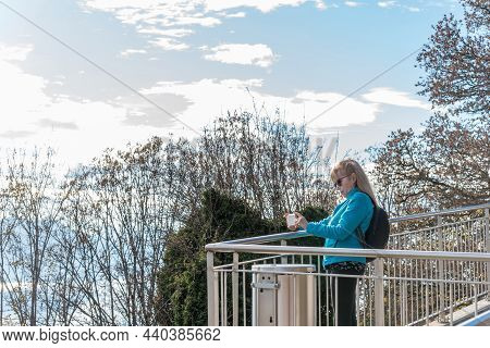 Blonde Woman With Sunglasses Taking Pictures Of Lake Geneva From The Viewpoint Of Mont Pelerin, Swit