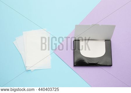 Package With Facial Oil Blotting Tissues On Color Background, Flat Lay. Mattifying Wipes
