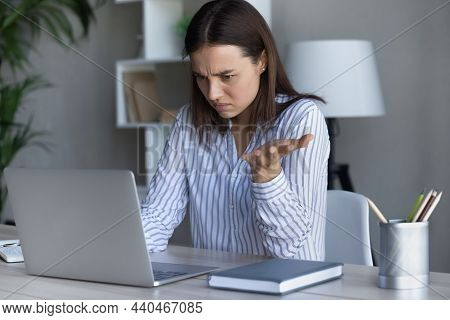 Confused Young Businesswoman Looking At Computer Screen.