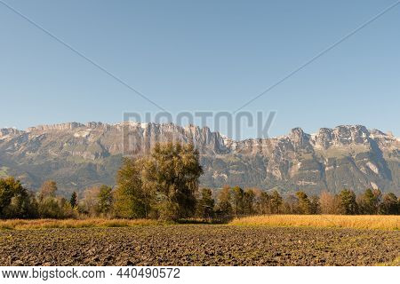 Schaan, Liechtenstein, October 14, 2021 Agriculture Field In Front Of The Alps On A Sunny Day