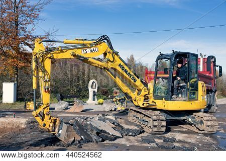 Brilon, Germany - November 10 2021: Excavator Busy With Removing Asphalt For Building A New Road