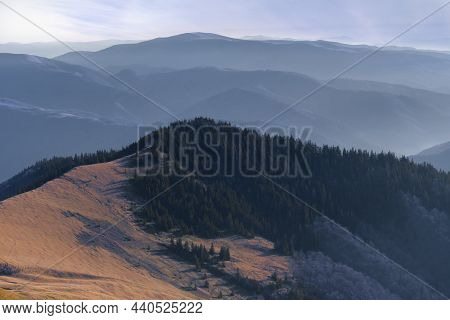 Mountain Peak Partially Covered With Green Trees And Beech Forest Against The Background Of A Ridge 