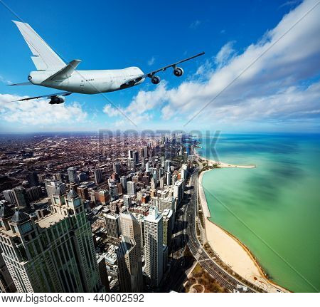 Tail View Of Jet Airplane Mid Air In Chicago City