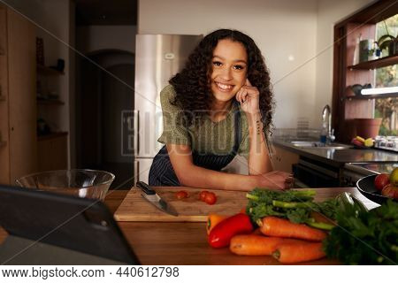 Portrait Of Multi-cultural Female Smiling In Her Modern Kitchen. Happy, Healthy And Confident At Hom