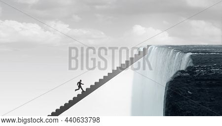 Fear And Courage Concept And Headed For Danger Business Idea As A Man Climbing Stairs Towards A Wate