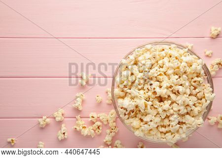 Popcorn In Glass Bowl On Pink Background.top Wiew.