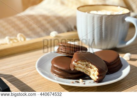 Tasty Choco Pies And Cup Of Hot Drink On Wooden Tray