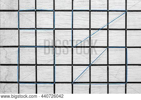 White Geoplane Made With Wood And Nails, Black Grids Painted With Office Elastics Forming Geometric 