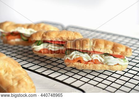 Fresh Baked Snack Eclairs Profiteroles With Creamcheese, Cucumber And Smoked Salmon Red Fish On A Ra