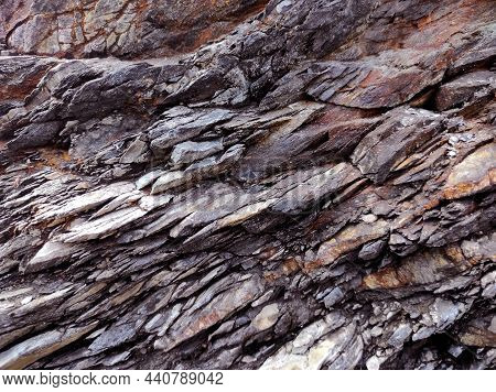 Geodesy. Stone Texture. The Rock Is Brown And Red. Mineral Background. Design From Natural Materials