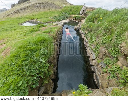 Man Relaxing In A Hot Spring Pool In Hrunalaug, Iceland
