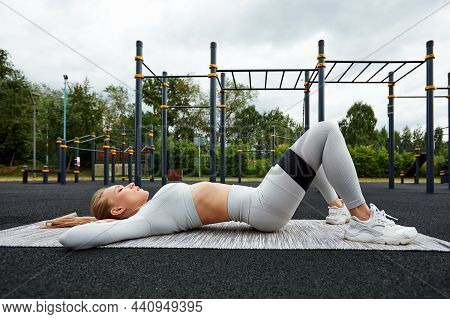 Resistance Band Fitness Outdoors. Young Athletic Woman With Perfect Body In Sportswear Doing Exercis