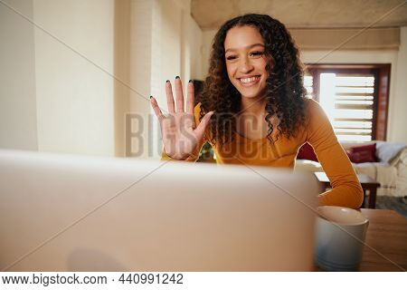 Multi-cultural Female Waving On A Online Meeting. Young Professional Remote Working With Laptop In M