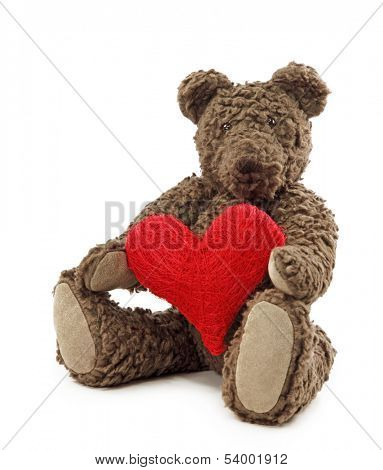 Teddy bear with red heart isolated on white background