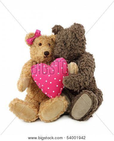 Two teddy bears with pink heart isolated on white background