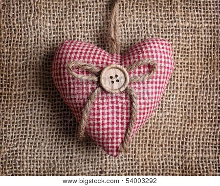 Heart with button on on brown sacking