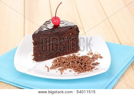 Chocolate sacher cake on wooden table