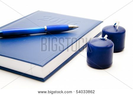 Notebook with pencil and candles