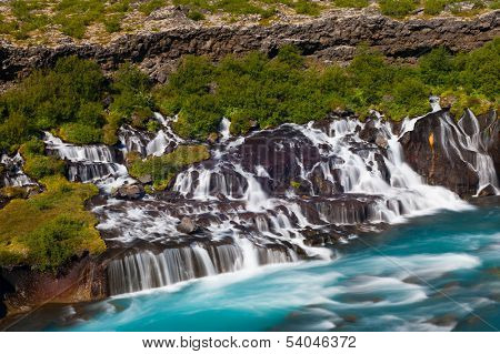Hraunfossar is a very beautiful Icelandic waterfall in the west of the island. It comes from the lava field and pours into the Hvita river with a incredibly blue water. Long exposure.