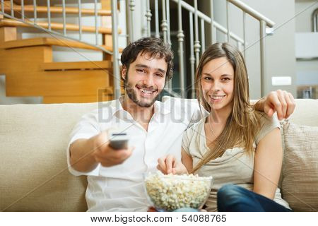 Young couple preparing to watch a movie