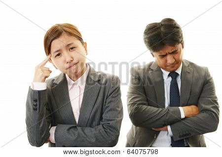 Disappointed businessman and businesswoman