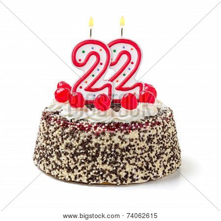 Birthday cake with burning candle number 22