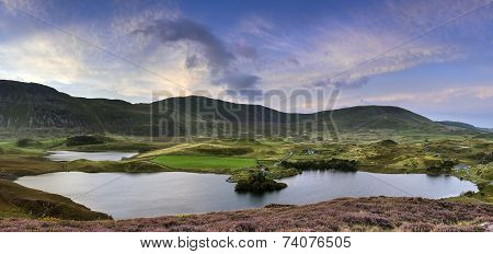 Stunning Sunrise Panorama Landscape Of Heather With Mountain Lake And Vibrant Sky
