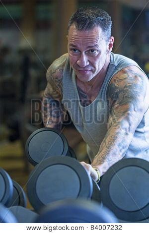 Man Making Dumbbell Kickback - Workout Routine .